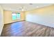 Bright bedroom with hardwood floors, ceiling fan and a window with lawn view at 2037 Lakeshore Dr, Mount Dora, FL 32757