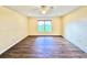 Bedroom featuring hardwood floors, ceiling fan and a window overlooking the lawn at 2037 Lakeshore Dr, Mount Dora, FL 32757