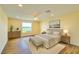 Bright bedroom with hardwood floors, large window, and neutral decor at 2037 Lakeshore Dr, Mount Dora, FL 32757