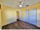 Bedroom with wood laminate flooring, ceiling fan, sliding door closet at 2037 Lakeshore Dr, Mount Dora, FL 32757