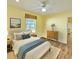 Cozy bedroom with wood floors, a ceiling fan, and neutral decor at 2037 Lakeshore Dr, Mount Dora, FL 32757