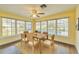 Inviting dining area surrounded by windows, wood floors, and views of the pool at 2037 Lakeshore Dr, Mount Dora, FL 32757