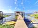 Picturesque boat dock on the water featuring a covered area for relaxing or fishing at 2037 Lakeshore Dr, Mount Dora, FL 32757