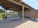 Covered dock featuring a relaxing porch swing and benches, great for entertaining or enjoying the waterfront at 2037 Lakeshore Dr, Mount Dora, FL 32757