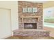 Charming stone fireplace with a rustic mantle and nautical décor in the corner of the sun room at 2037 Lakeshore Dr, Mount Dora, FL 32757