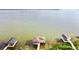 Stunning view features a lakefront property with multiple docks and lush greenery at 2037 Lakeshore Dr, Mount Dora, FL 32757