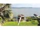 Breathtaking view of a waterfront property featuring a dock and lush green surroundings at 2037 Lakeshore Dr, Mount Dora, FL 32757