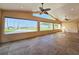 Spacious living room featuring large windows with stunning water views and ceiling fans at 2037 Lakeshore Dr, Mount Dora, FL 32757