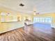 Spacious living room with hardwood floors and plenty of natural light from the large windows at 2037 Lakeshore Dr, Mount Dora, FL 32757