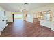 Open-concept living room with wood-look flooring, a fireplace and kitchen access at 2037 Lakeshore Dr, Mount Dora, FL 32757
