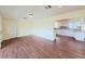 Hardwood floors and an archway to the kitchen with white cabinets and countertops at 2037 Lakeshore Dr, Mount Dora, FL 32757