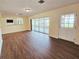 Bright living room with hardwood floors and an adjacent patio view at 2037 Lakeshore Dr, Mount Dora, FL 32757