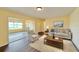 Comfortable living room with hardwood flooring, neutral tones, sliding glass doors to a patio area at 2037 Lakeshore Dr, Mount Dora, FL 32757