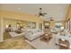 Bright living room with ceiling fans, a stone fireplace, comfortable seating, and sliding glass doors to outdoor space at 2037 Lakeshore Dr, Mount Dora, FL 32757