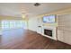 Living room with built-in shelving, fireplace and big picture windows at 2037 Lakeshore Dr, Mount Dora, FL 32757