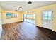 Living room with hardwood floors that connects to a sunroom, offering bright, open living space at 2037 Lakeshore Dr, Mount Dora, FL 32757
