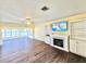 Cozy living room with wood floors, electric fireplace, and built-in shelving at 2037 Lakeshore Dr, Mount Dora, FL 32757