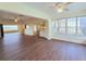 Open-concept living room showing wood-look floors and kitchen access at 2037 Lakeshore Dr, Mount Dora, FL 32757