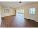 Open-concept living room with hardwood floors and a view of the enclosed patio at 2037 Lakeshore Dr, Mount Dora, FL 32757
