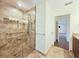 Modern walk-in shower featuring a glass door, body jets, and decorative tile at 2037 Lakeshore Dr, Mount Dora, FL 32757