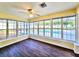 Sunroom filled with natural light, hardwood floors, and views of the pool and backyard at 2037 Lakeshore Dr, Mount Dora, FL 32757