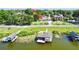 Enjoy waterfront living with access to private boat slips, complemented by a lush green lawn and beautiful landscaping at 2037 Lakeshore Dr, Mount Dora, FL 32757