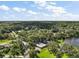 Expansive aerial view of the estate with a lake and lush green foliage, creating a private oasis at 2121 Suzanne Dr, Mount Dora, FL 32757