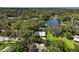 Aerial view of a home surrounded by trees, with a lake nearby at 2121 Suzanne Dr, Mount Dora, FL 32757
