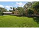Expansive backyard with lush green lawn, mature trees and additional outbuilding that provide ample outdoor space at 2121 Suzanne Dr, Mount Dora, FL 32757