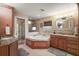 A luxurious bathroom with a soaking tub and dual vanity with granite countertops at 2121 Suzanne Dr, Mount Dora, FL 32757