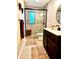 Bathroom with tile flooring, a sliding glass shower, and a stained vanity at 2121 Suzanne Dr, Mount Dora, FL 32757