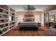Cozy bedroom with a comfortable bed, built-in bookshelves, and hardwood floors at 2121 Suzanne Dr, Mount Dora, FL 32757