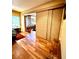 Bedroom featuring wood-look tile flooring and sliding doors to an office at 2121 Suzanne Dr, Mount Dora, FL 32757