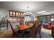 Elegant dining area featuring a chandelier, hardwood floors, and views into the kitchen and living spaces at 2121 Suzanne Dr, Mount Dora, FL 32757