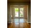 A home's entryway with access to the front yard through french doors. Lush landscaping is visible at 2121 Suzanne Dr, Mount Dora, FL 32757