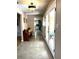 Hallway with a bench, tile flooring, and view to a white kitchen with appliances at 2121 Suzanne Dr, Mount Dora, FL 32757