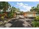 Charming single-story home with a lush front yard and a two-car garage at 2121 Suzanne Dr, Mount Dora, FL 32757
