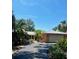 Beautiful single Gathering home featuring a long driveway, lush landscaping, and an attached garage at 2121 Suzanne Dr, Mount Dora, FL 32757