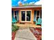 Charming front porch with seating and blue shutters framing the door of this single Gathering home at 2121 Suzanne Dr, Mount Dora, FL 32757