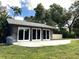 Detached garage with three bays, each with large doors, set against a backdrop of mature trees at 2121 Suzanne Dr, Mount Dora, FL 32757
