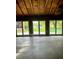 Spacious garage interior with multiple doors leading to a backyard view at 2121 Suzanne Dr, Mount Dora, FL 32757