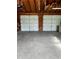 Spacious empty garage with two doors and overhead storage, ready for your vehicles and projects at 2121 Suzanne Dr, Mount Dora, FL 32757