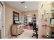 Hallway featuring a decorative dresser, adjacent to the bedroom, with a comfortable workspace at 2121 Suzanne Dr, Mount Dora, FL 32757
