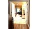 Hallway showcasing a bedroom area with wood floors, built-in shelving, and an open doorway at 2121 Suzanne Dr, Mount Dora, FL 32757