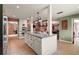 Bright kitchen with an island, modern appliances, tile floors, and views into other living spaces at 2121 Suzanne Dr, Mount Dora, FL 32757