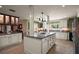 Well-lit kitchen with a central island, white cabinetry, stainless steel appliances, and tile flooring at 2121 Suzanne Dr, Mount Dora, FL 32757