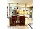 Kitchen featuring an island with seating, stainless steel appliances, and custom lighting at 2121 Suzanne Dr, Mount Dora, FL 32757