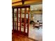 Open floor plan featuring wood sliding doors and a view of the dining room at 2121 Suzanne Dr, Mount Dora, FL 32757