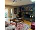 Living room with a stone fireplace, hardwood floors, and natural lighting at 2121 Suzanne Dr, Mount Dora, FL 32757