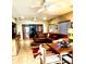 Open-concept living room with ceiling fans, stylish rug, comfortable seating, and dining area at 2121 Suzanne Dr, Mount Dora, FL 32757
